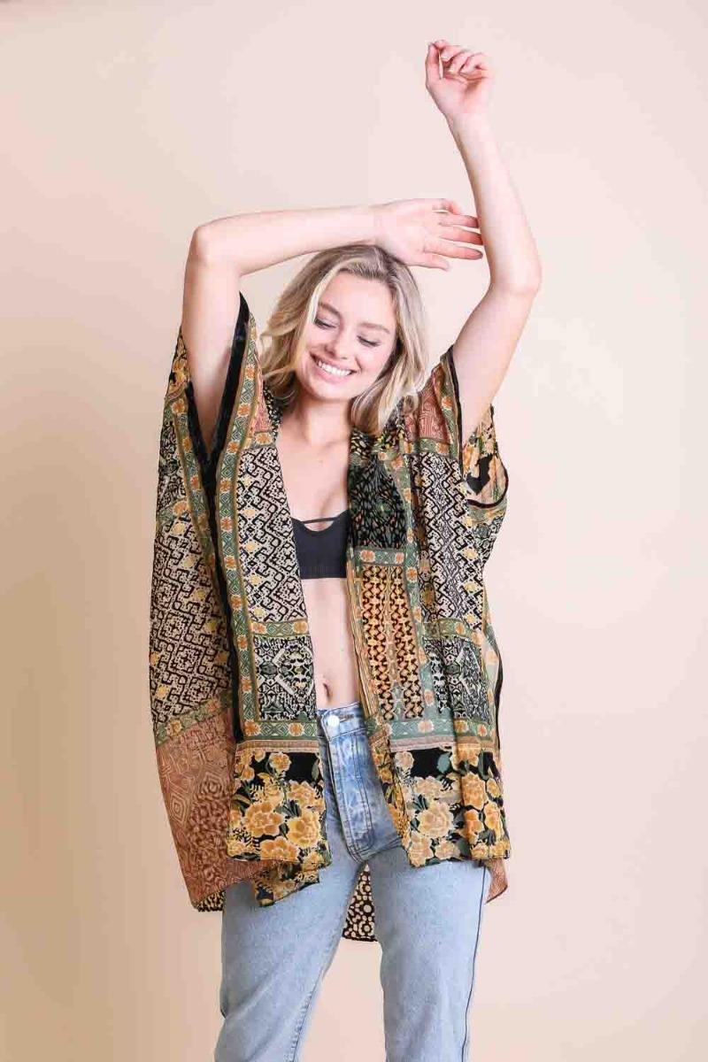 Woman in a bohemian chic black and mustard floral kimono perfect for casual wear
