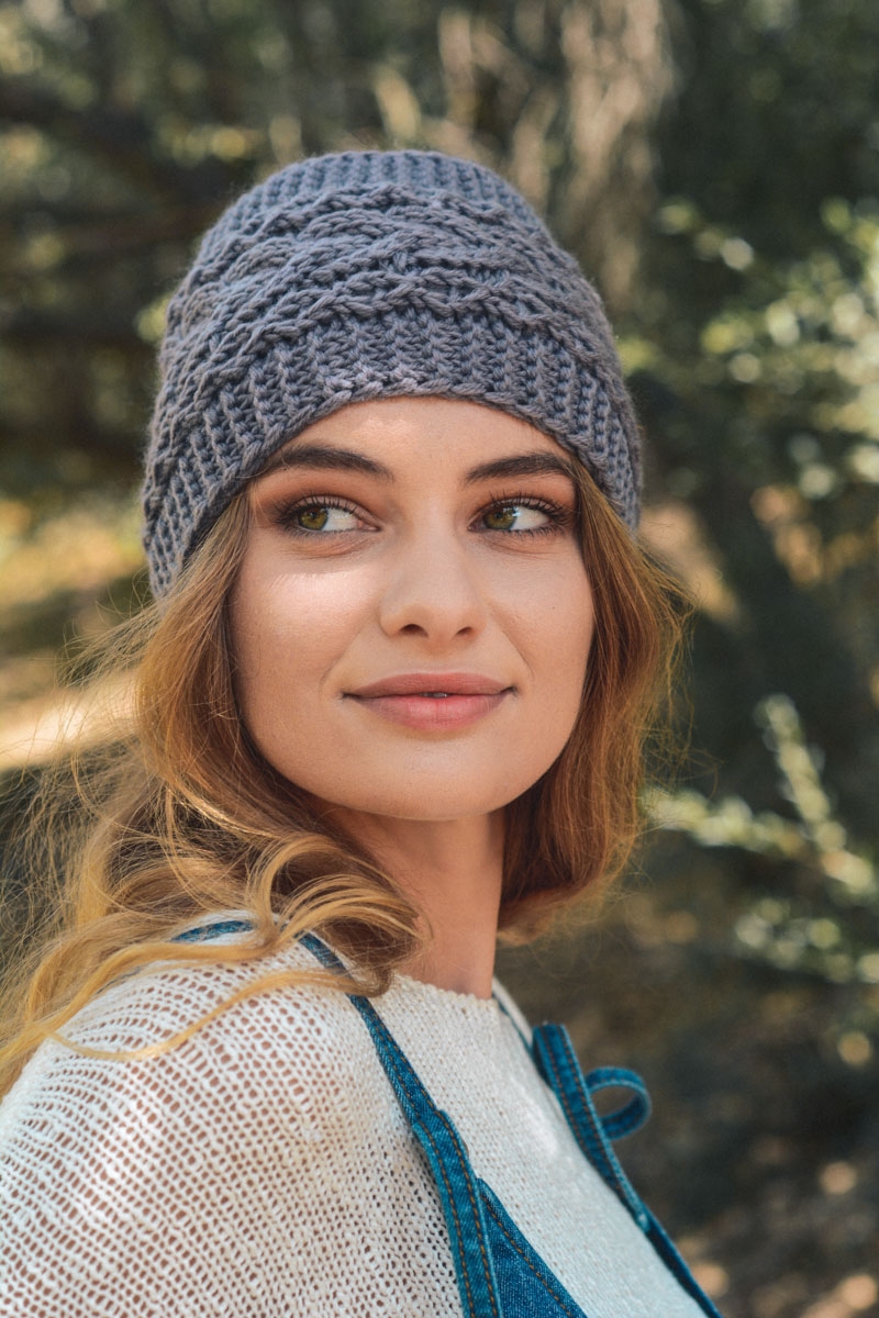 Gray cable knit headband designed for comfort and warmth during cold weather.