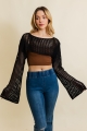 Black crochet bell sleeve top on model with fashion jeans