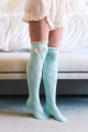 Chic bow-adorned thigh highs with a diamond pattern, elegant mint design for stylish wear.