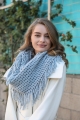 Blue lattice-knit tassel infinity scarf, perfect for adding warmth and style to any winter outfit.