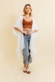 Front look of young woman in ivory kimono paired with casual jeans