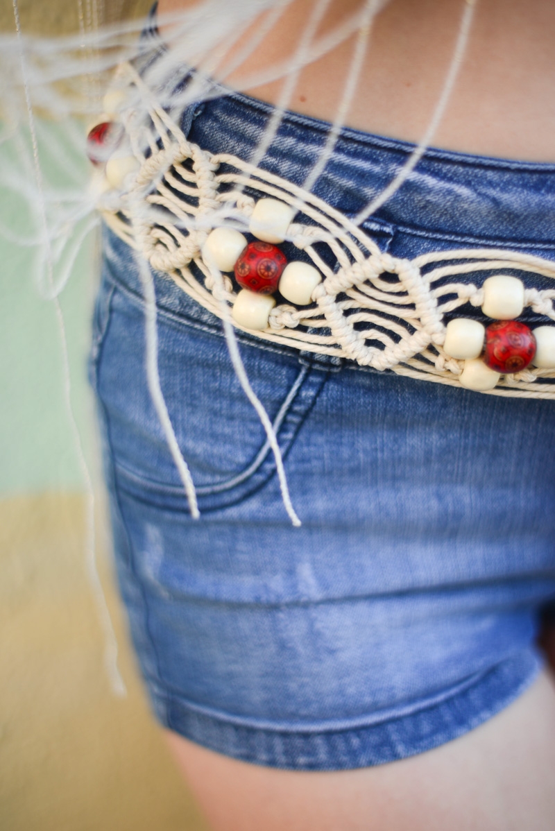 White boho macrame waist belt with fringe and tassel details, a stylish accessory for any outfit.