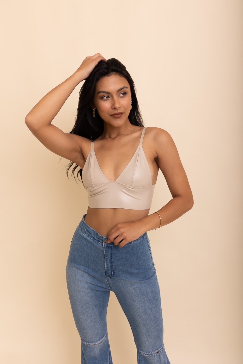 Faux leather long-line bralette with a deep V-neck design, perfect for a bold and stylish look.