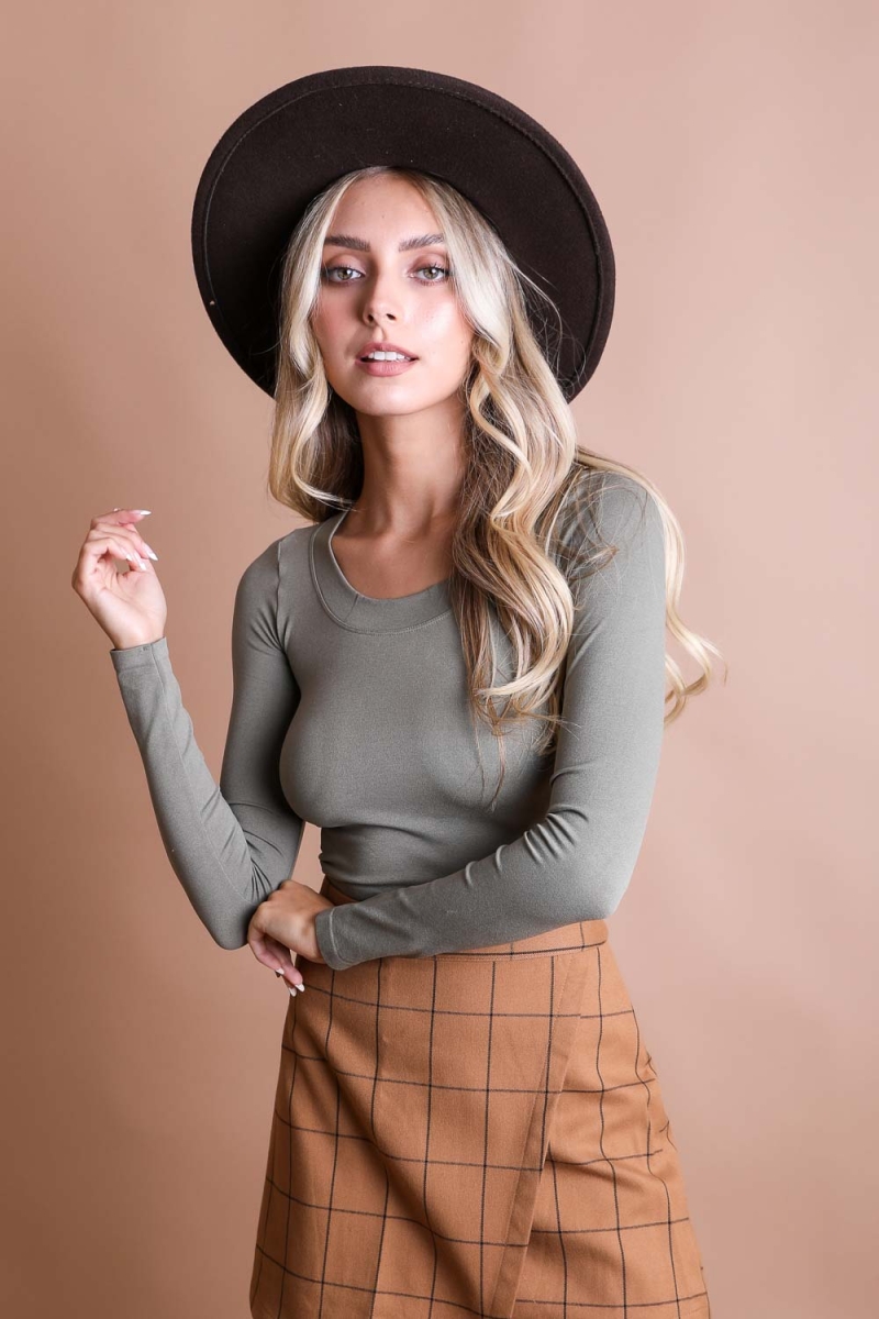 Fitted long sleeve crop top in sage green, ideal for layering or casual wear.