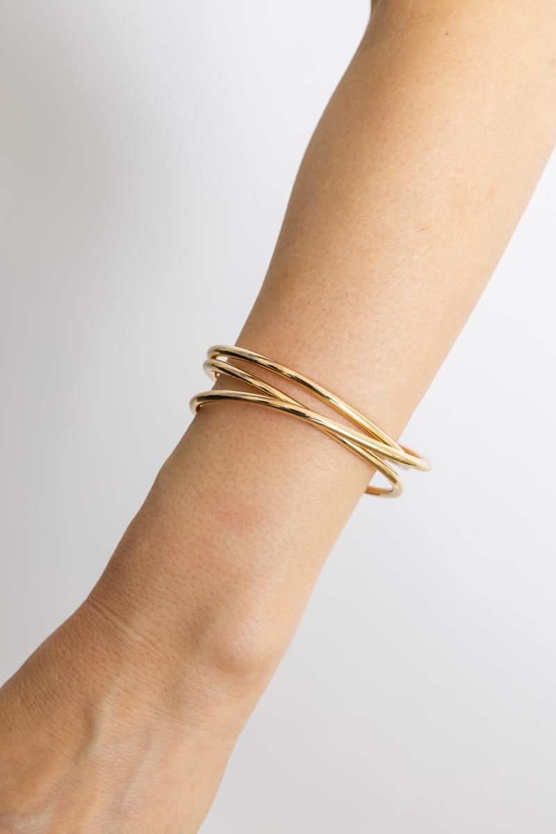 Gold Evolve layered cuff bracelet on model, fashion-forward design