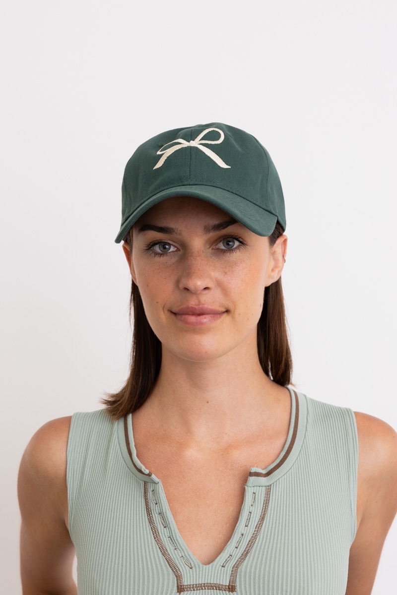 Green bow ribbon adjustable baseball cap with embroidered ribbon detail.