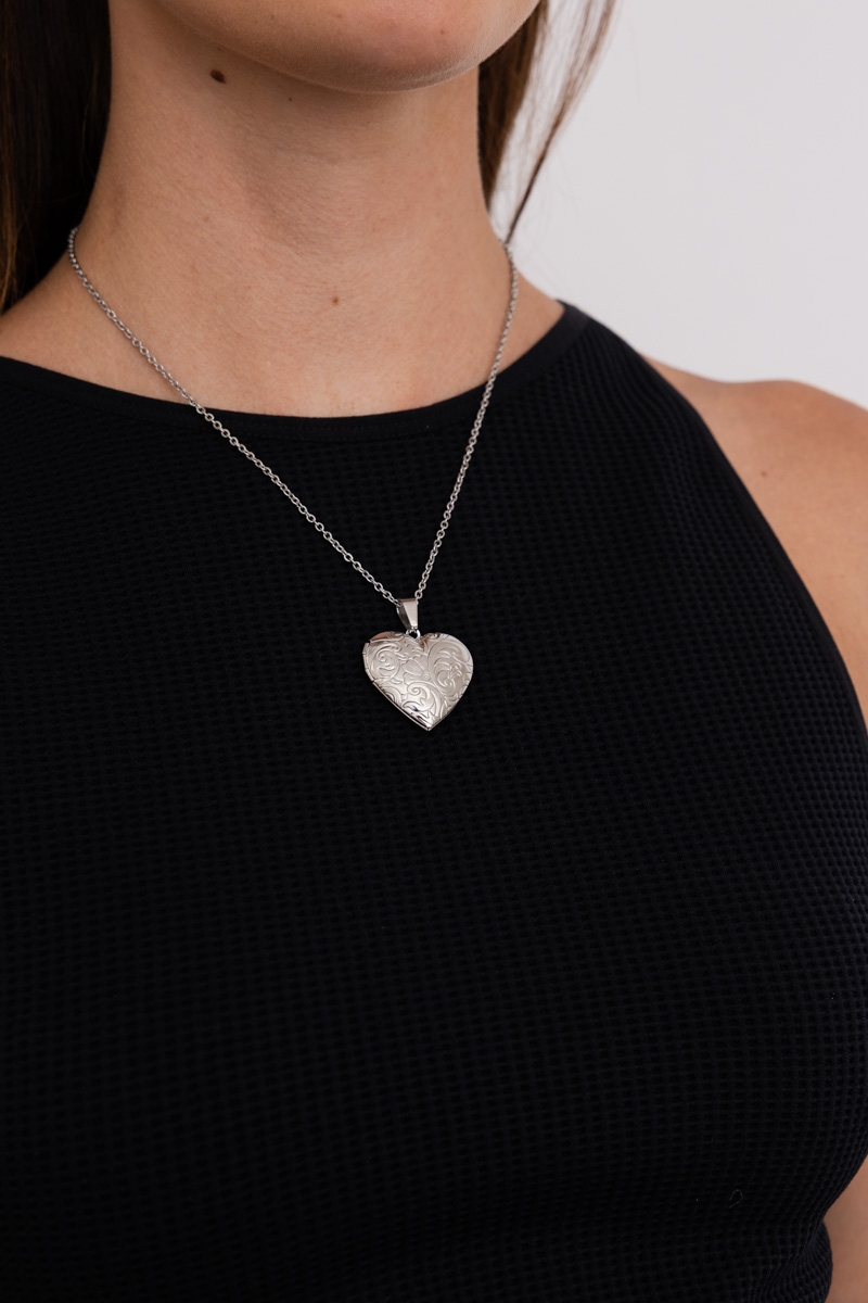 Love me heart locket pendant necklace with a romantic design, worn by model