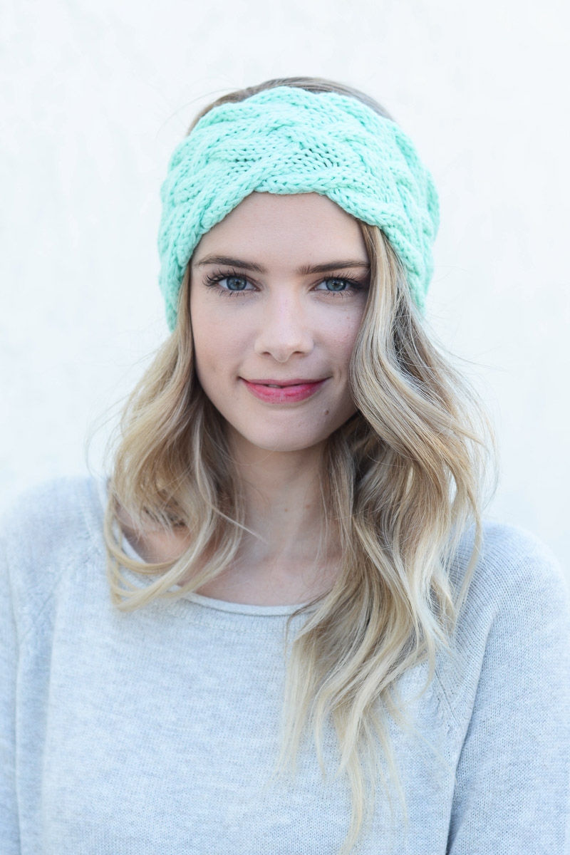 Pastel mint braided cable knit headband featuring a cozy winter design.