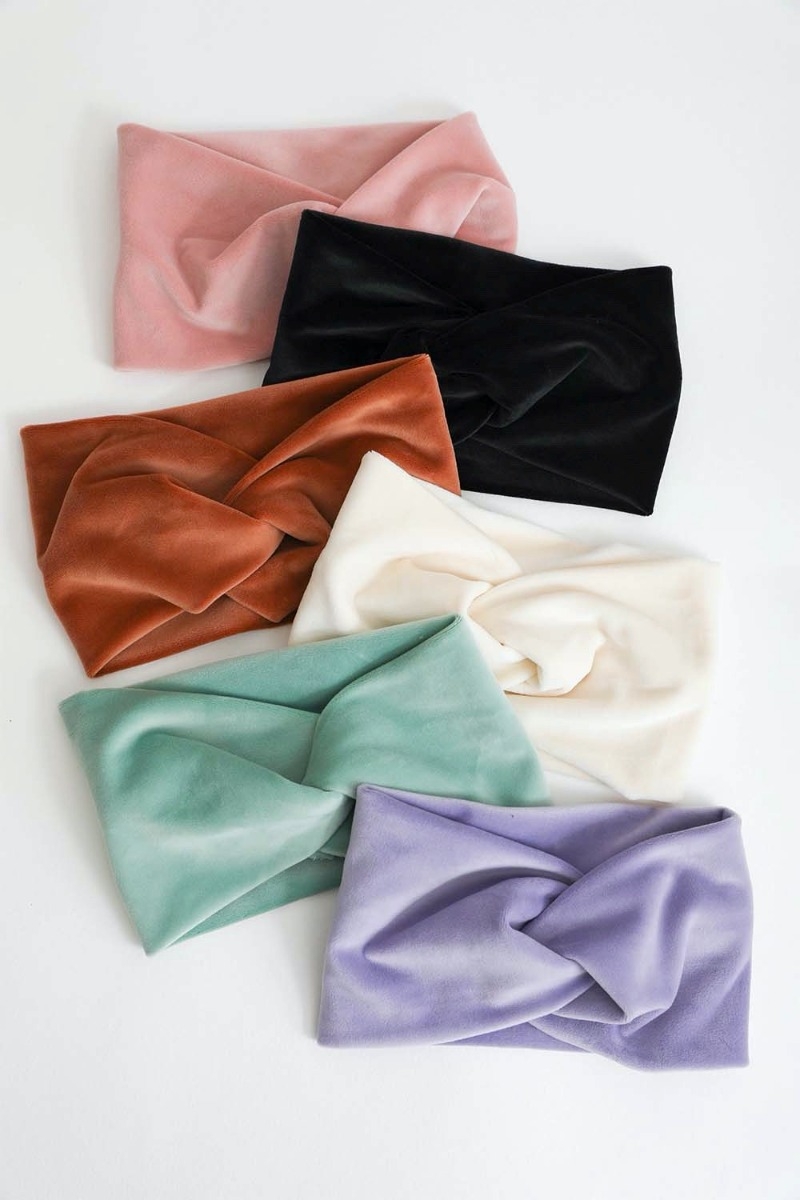 Assorted velvet knot headbands in soft pastel and bold hues, perfect for a chic and comfortable hair accessory.
