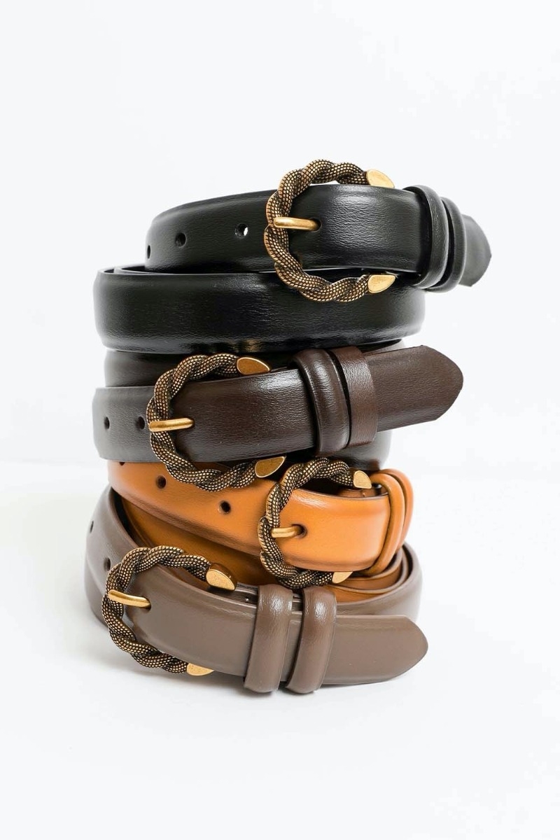 Close-up of vintage two-tone twisted buckle leather belt detail