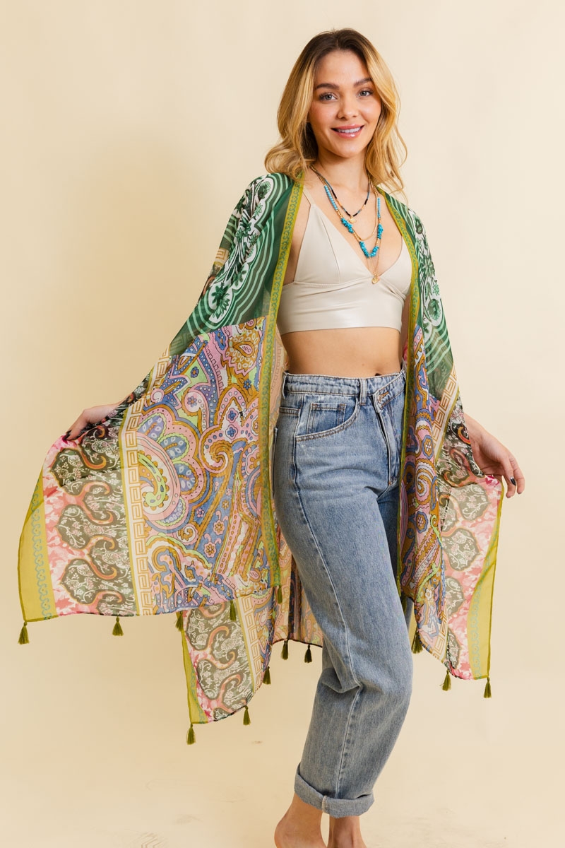 Young woman modeling a lime boho kimono with detailed paisley designs and tassel accents