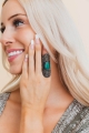 Close-up of a model wearing the vintage turquoise gemstone ring with antique detailing